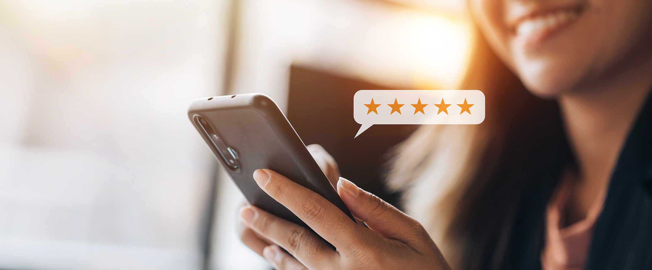 A person submits an online review using a mobile phone